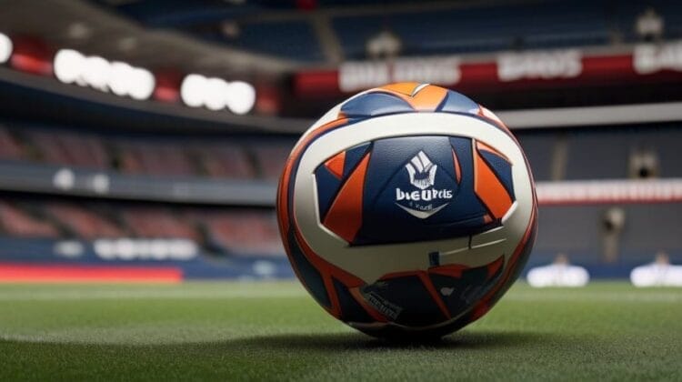 Close-up of a soccer ball branded "beau jeu" on a grass field with an empty stadium in the background where the manager installs horny style on the pitch with new equipment.