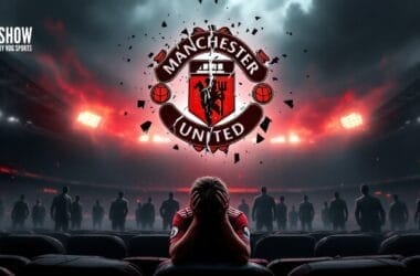 A person sits with their head in hands in a stadium, facing the Manchester United logo, perhaps pondering the decisions made during Ed Woodward's tenure.