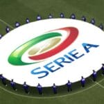 A group of people standing around an Italian football field with the Serie A logo.