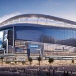 Modern stadium with large screens and distinctive tower nearby, bathed in the warm hues of sunset, surrounded by a bustling cityscape. The air is abuzz with excitement as fans discuss the potential NHL team relocation bringing fresh energy to the town.