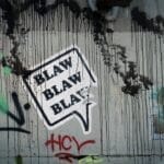 Graffiti on a wall with a speech bubble saying "BLAW BLAW BLAW," where black drips and colorful tags dance around unpopular sports opinions.