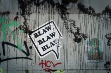 Graffiti on a wall with a speech bubble saying "BLAW BLAW BLAW," where black drips and colorful tags dance around unpopular sports opinions.