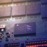 In soft lighting, a close-up reveals a computer circuit board with microchips and electronic components, resembling the precision and strategy akin to decision making in the NFL.