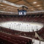 From the stands, witness an NHL Fan Experience in this empty hockey arena as teams face off on the ice. The energy is palpable even without a crowd, offering a unique perspective on the sport.